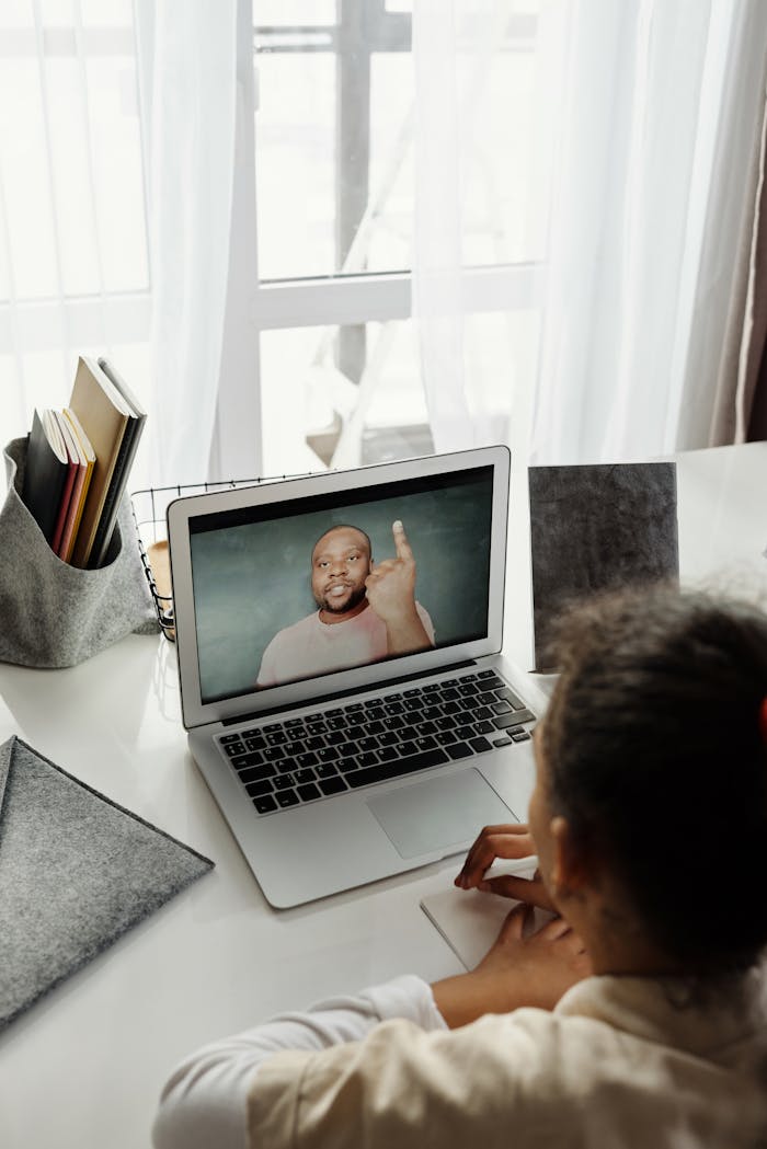 Young girl attending virtual class from home during pandemic.